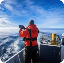 Researcher recording observations from a vessel