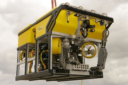 Yellow Holland I remotely operated vehicle suspended by a lifting cable.